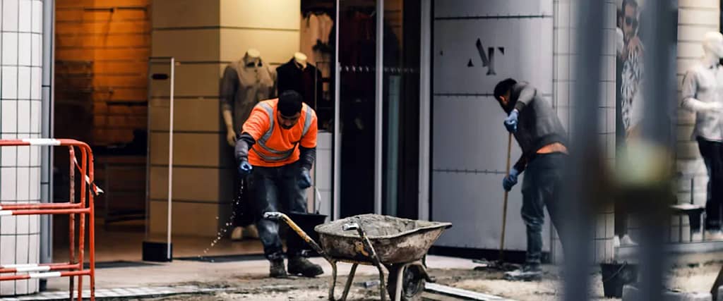 Crew performing exterior renovation in a commercial shopping area